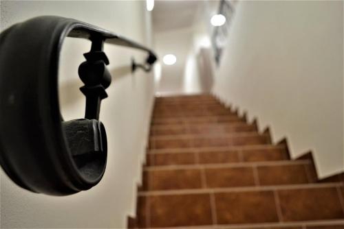 a hallway with a door with a hand rail and stairs at Pension Kotva in Beroun