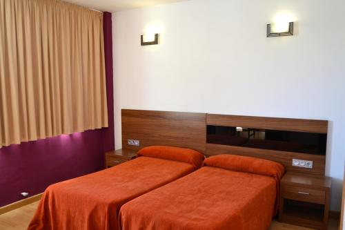 En eller flere senge i et værelse på Hotel El Cruce