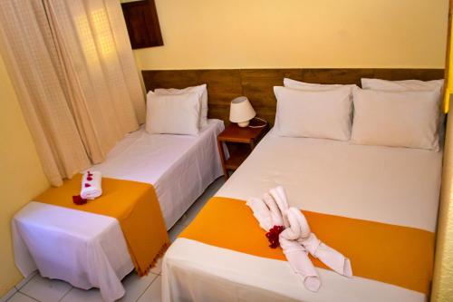 Ένα ή περισσότερα κρεβάτια σε δωμάτιο στο Pousada Sitio Araça