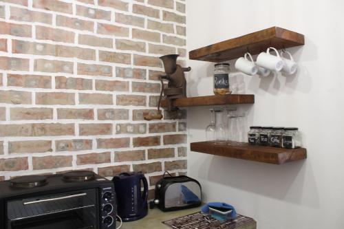 a kitchen with a brick wall and a stove at 19 on Micro Avenue in Strand