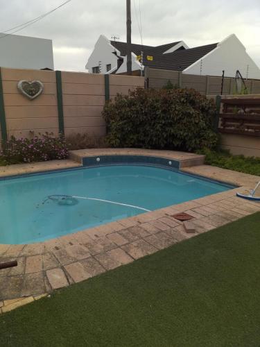 a small swimming pool in a yard with grass at 19 on Micro Avenue in Strand