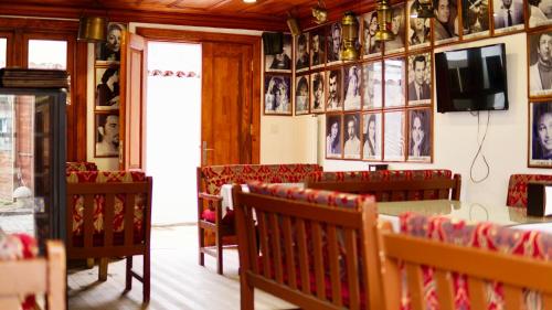a dining room with benches and pictures on the walls at QONAQ HOTEL & SUITES in Istanbul
