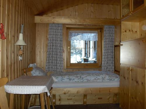 a bedroom with a bed and a window at Haus Moosbach in Oberwössen