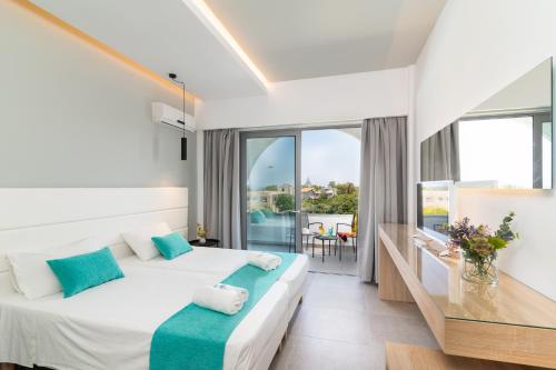 a hotel room with two beds and a balcony at Happy Days Hotel, Adults Only in Theologos