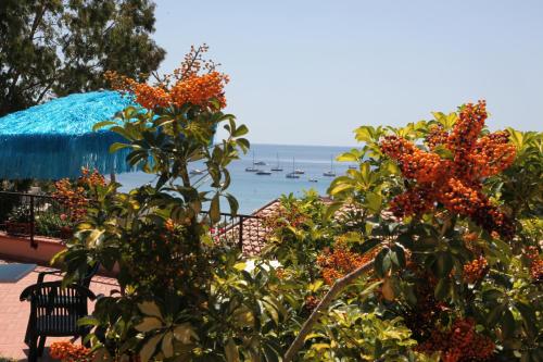 a view of the ocean with boats in the water at Hotel Lo Scirocco in Campo nell'Elba