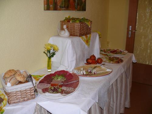 a table with plates of food on top of it at Pension Kreisel in Bad Kösen