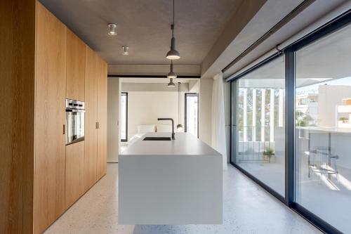 a kitchen with a white island in a house at Ogarden in Athens