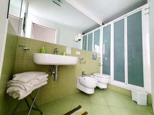 a bathroom with a sink and a toilet at Terrazze Villanova in Trapani
