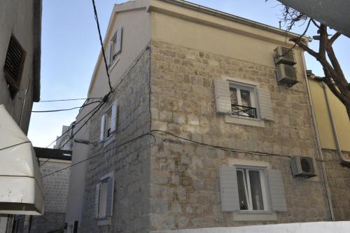 a tall brick building with a window on it at Merla Luxury Rooms in Split