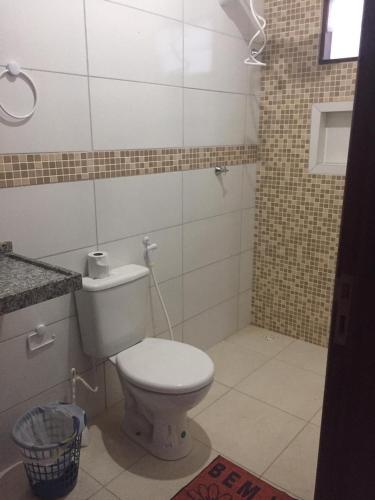 a bathroom with a white toilet and a mirror at Casa do Francês Temporada in Marechal Deodoro