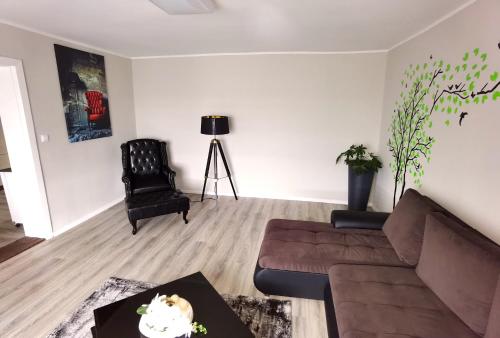 a living room with a couch and a table at Apart Oderblick in Neubleyen