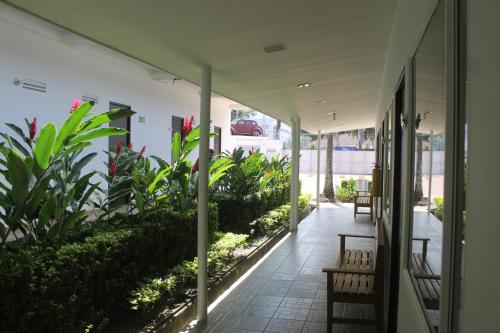 a hallway with benches and plants in a building at Hotel Manantial Melgar Torre 2 in Melgar