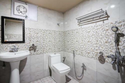 a bathroom with a toilet and a sink at Glamwood Resort Dhanaulti, Ranked 1 in Dhanaulti in Dhanaulti