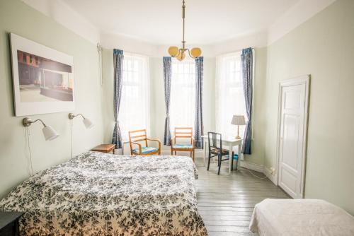 a bedroom with a bed and a table and chairs at STF Villa Söderåsen B&B in Röstånga