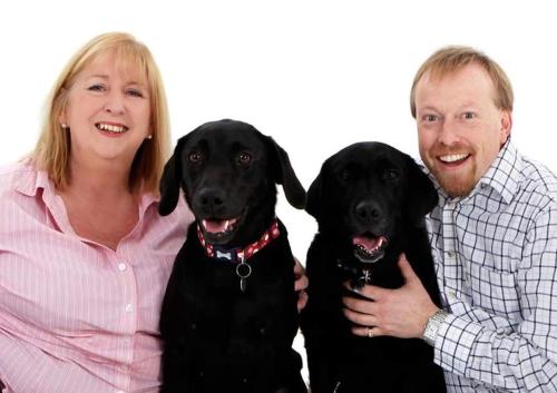 a man and a woman holding a black dog at Orchard Lodge & Wolds Restaurant in Cayton