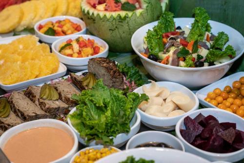 a table topped with bowls of different types of food at ONOMO Hotel Douala in Douala