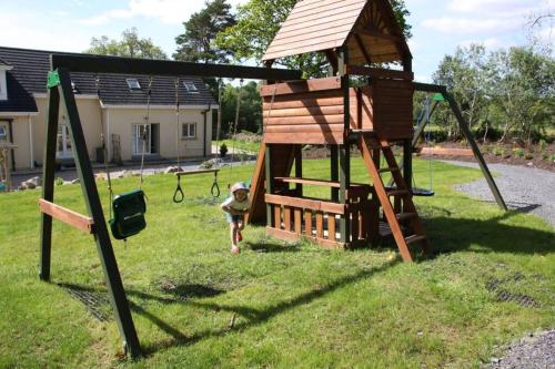 a little girl is playing in a playground at Canal bank house in Bellanaboy