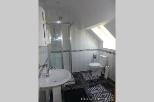 a bathroom with a sink and a toilet at Canal bank house in Bellanaboy
