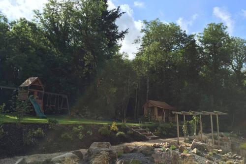 a park with a playground and a house at Canal bank house in Bellanaboy