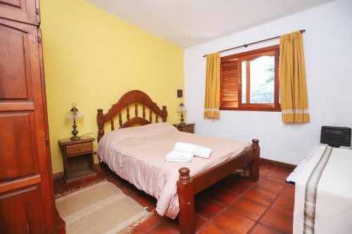 a bedroom with a bed and a window at Cabaña Modestita - FINCA PUDUAM in Villa General Belgrano