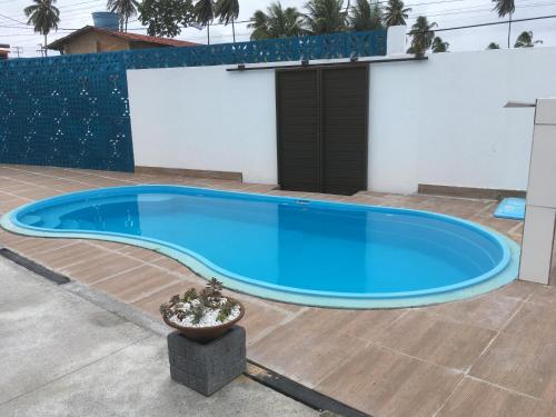 a large blue swimming pool in front of a building at Pousada Brisa e Mar in Praia do Frances