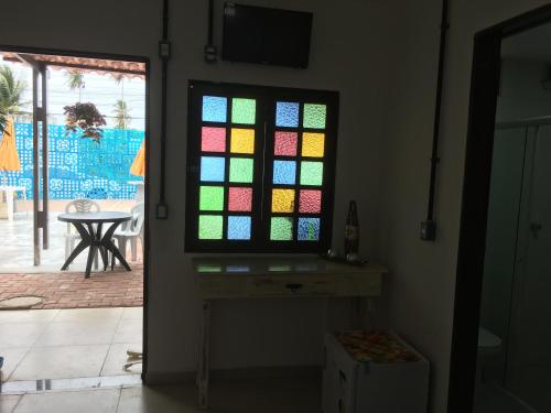 a stained glass window in a room with a patio at Pousada Brisa e Mar in Praia do Frances