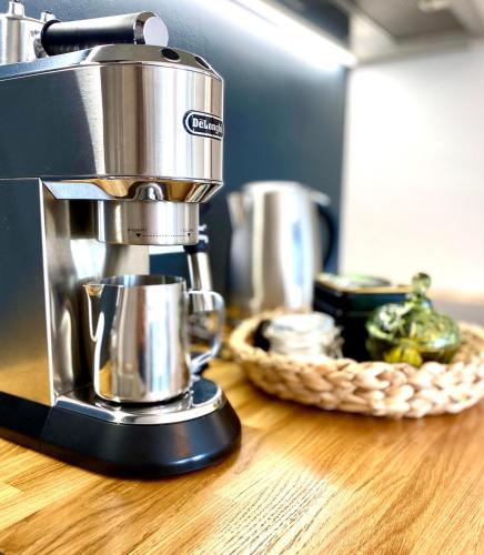a coffee maker on a counter with a basket of food at Cesis Boulevard Apartments in Cēsis