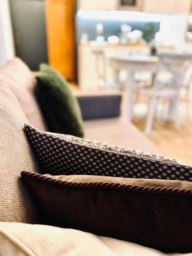 a couple of pillows sitting on a couch at Cesis Boulevard Apartments in Cēsis