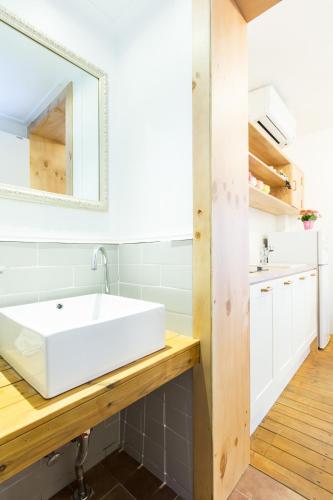 a bathroom with a white sink and a mirror at Hotel Gaon Seoul Dongdaemun in Seoul