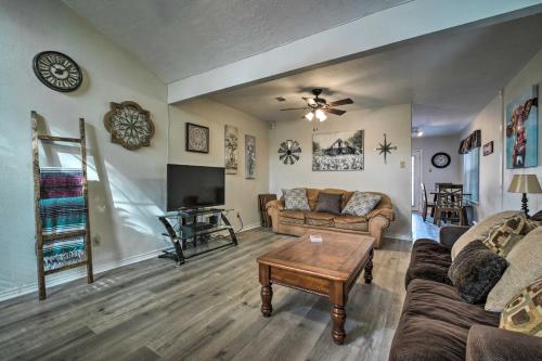 a living room with a couch and a tv at Bright College Station Abode 3 Mi to Kyle Field in Bryan
