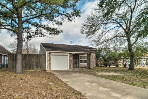 a brick house with a garage and a fence at Bright College Station Abode 3 Mi to Kyle Field in Bryan