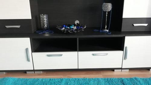 a white entertainment center with a black counter top at ANKER SILVER DREAM in Kaposvár
