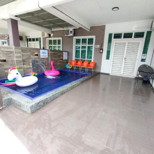 a swimming pool with a toy poolvisor in a house at D'Q Putra Homestay Melaka (Unit AMAR) in Melaka