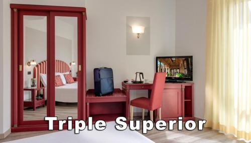 a hotel room with a red desk and a bedroom at Hotel Da Vinci in Montecatini Terme