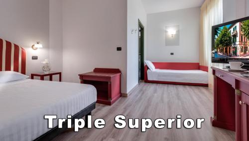 a hotel room with a bed and a tv at Hotel Da Vinci in Montecatini Terme