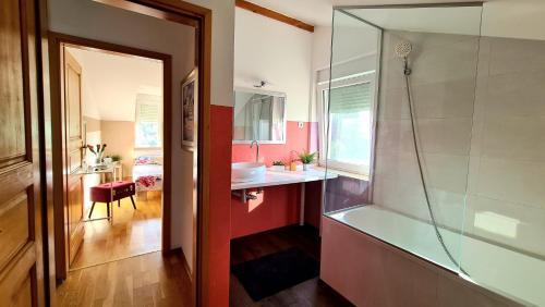 a bathroom with a shower and a sink and a tub at Villa Sunshine in Pula