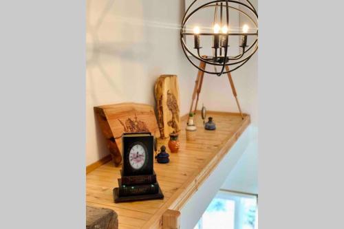 a shelf with a clock and a lamp on it at Villa Aquila in Beli Iskar