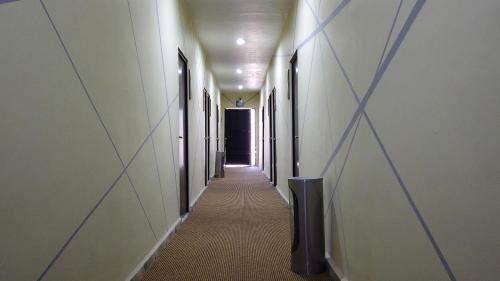 a hallway with a long corridor with a black door at Hotel Town Express in Durango