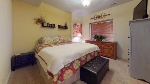 a bedroom with a bed and a dresser and a window at 120 Winding Meadow by Vacation Rentals for You in Monument