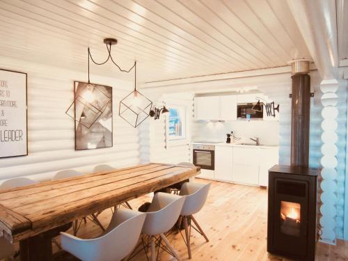 a kitchen with a wooden table and chairs and a stove at Mountain Chalet in Covilhã