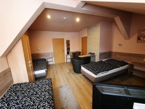 a large room with two beds and a couch at Penzion Avena in Stříbro