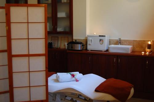 a kitchen with a table and a counter with towels at Hotelik Villa Eden & SPA in Suwałki