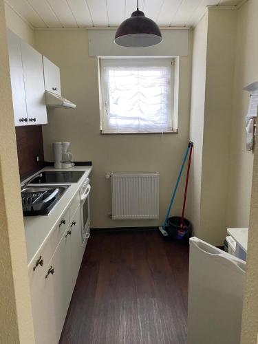 a kitchen with a sink and a window with a mop at casa mediterranea in Herzogenrath