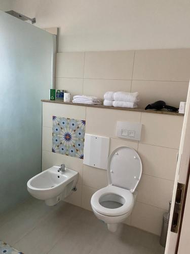 a bathroom with a toilet and a sink at casa mediterranea in Herzogenrath