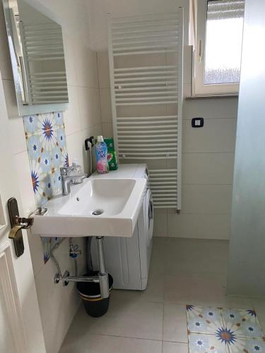 a bathroom with a white sink and a window at casa mediterranea in Herzogenrath