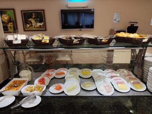 a buffet line with many different types of food at Viale Tower Hotel in Foz do Iguaçu