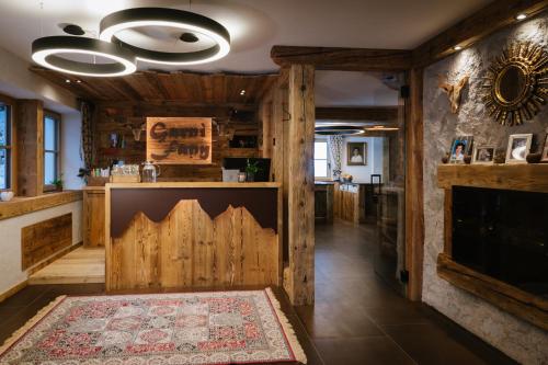 a living room with wooden walls and a fireplace at Garni Fany in Colfosco