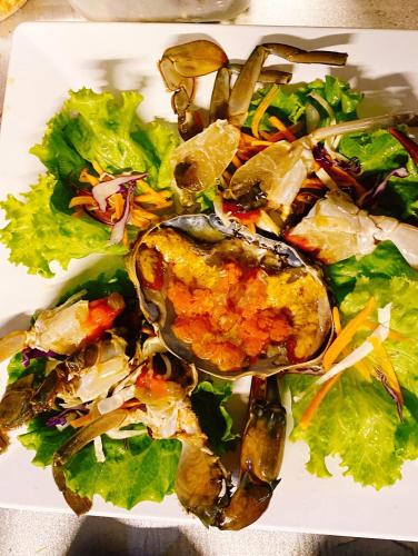 a plate of food with a salad on it at Villa PaSon in Khao Kho