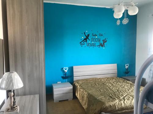 a blue bedroom with a bed and a blue wall at Vacanze da Emanuele in Otranto