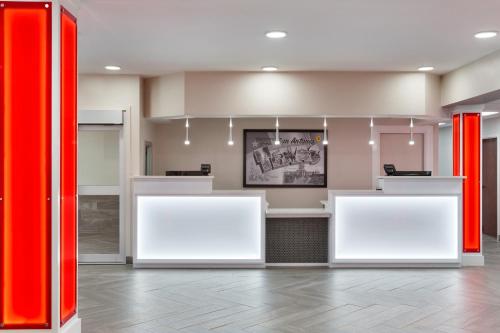 an empty waiting room with red dividers in a lobby at Super 8 by Wyndham San Antonio Airport North in San Antonio